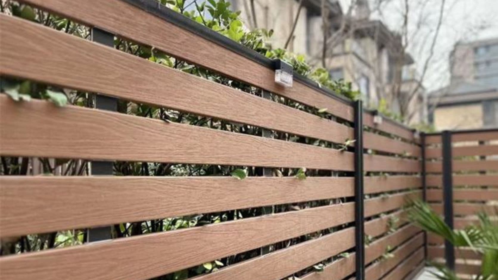 White vinyl privacy fence panel installation in a residential backyard