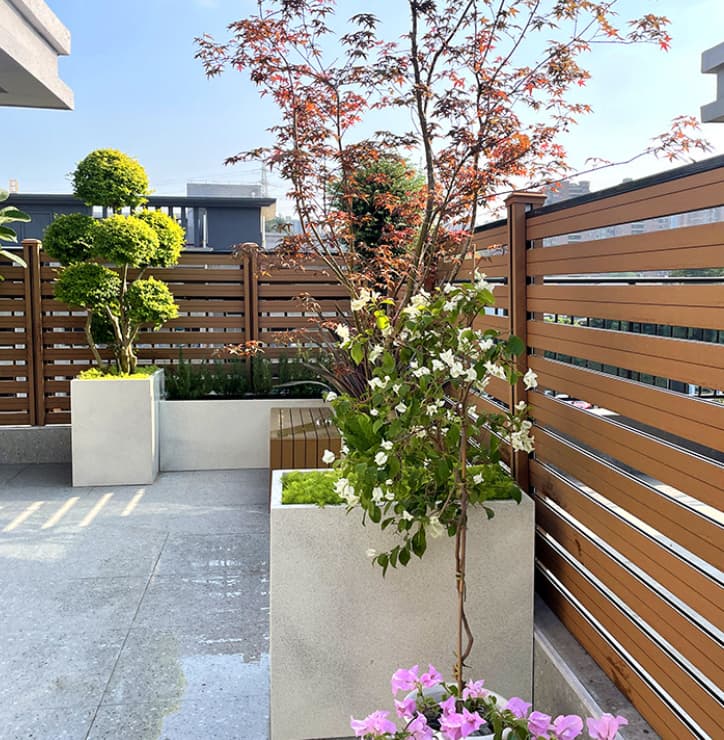 Necowood WPC fence panels with matching gate system at a residential community entrance